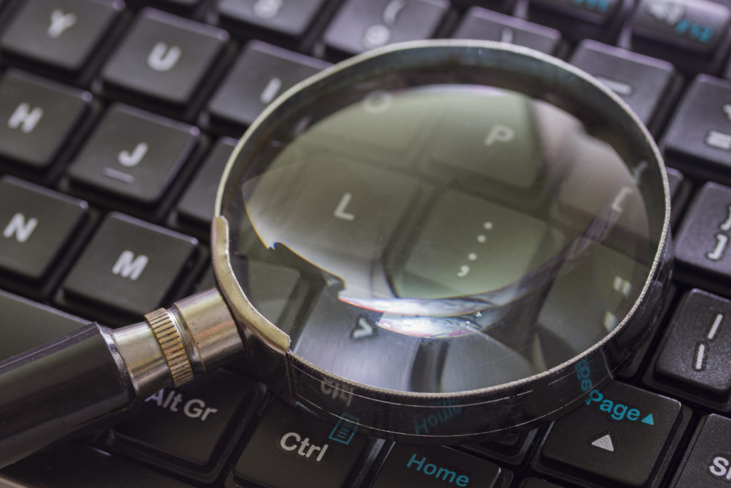 Magnifying glass on computer keyboard